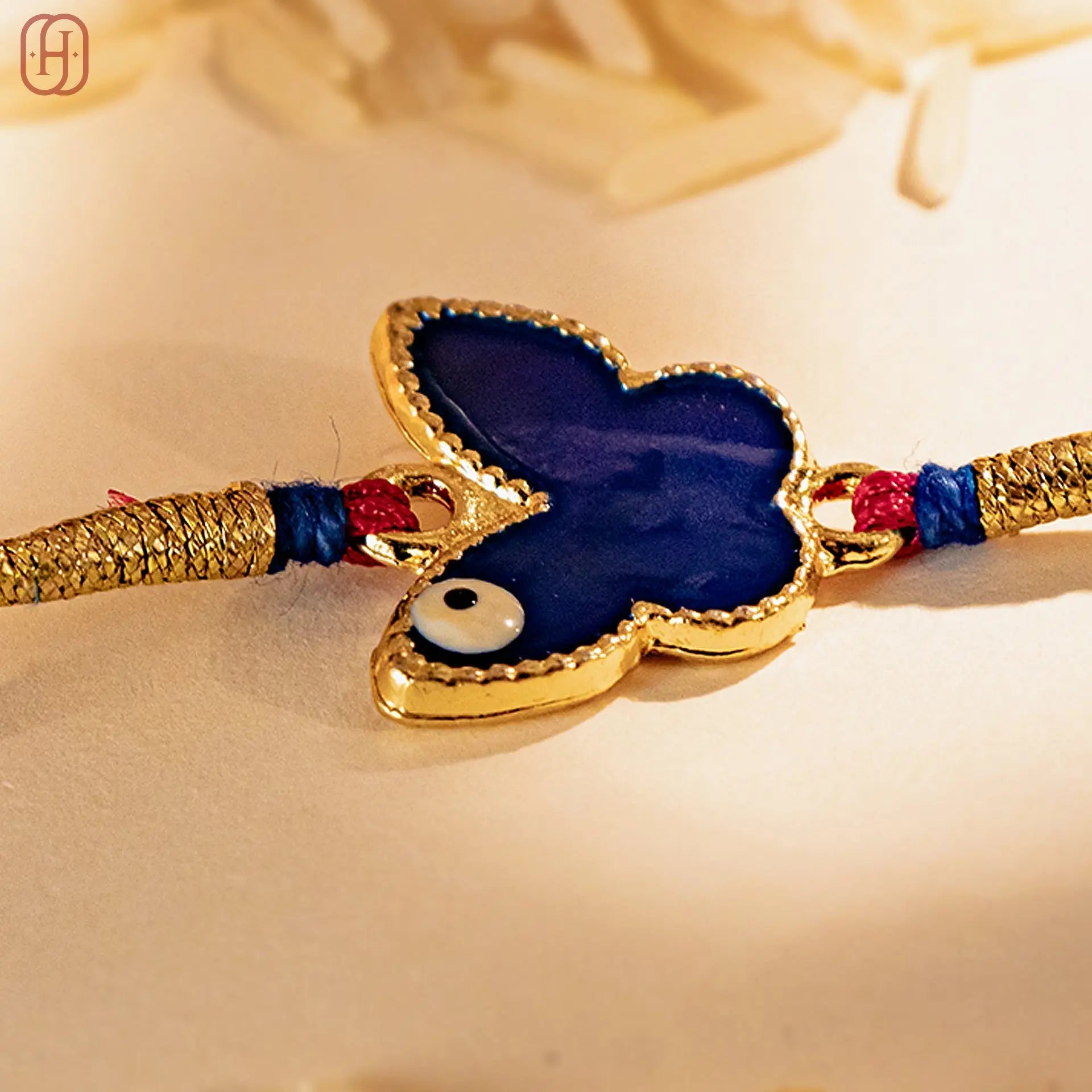 Hardik Jewels Butterfly Silver Rakhi with Blue Enamel.
