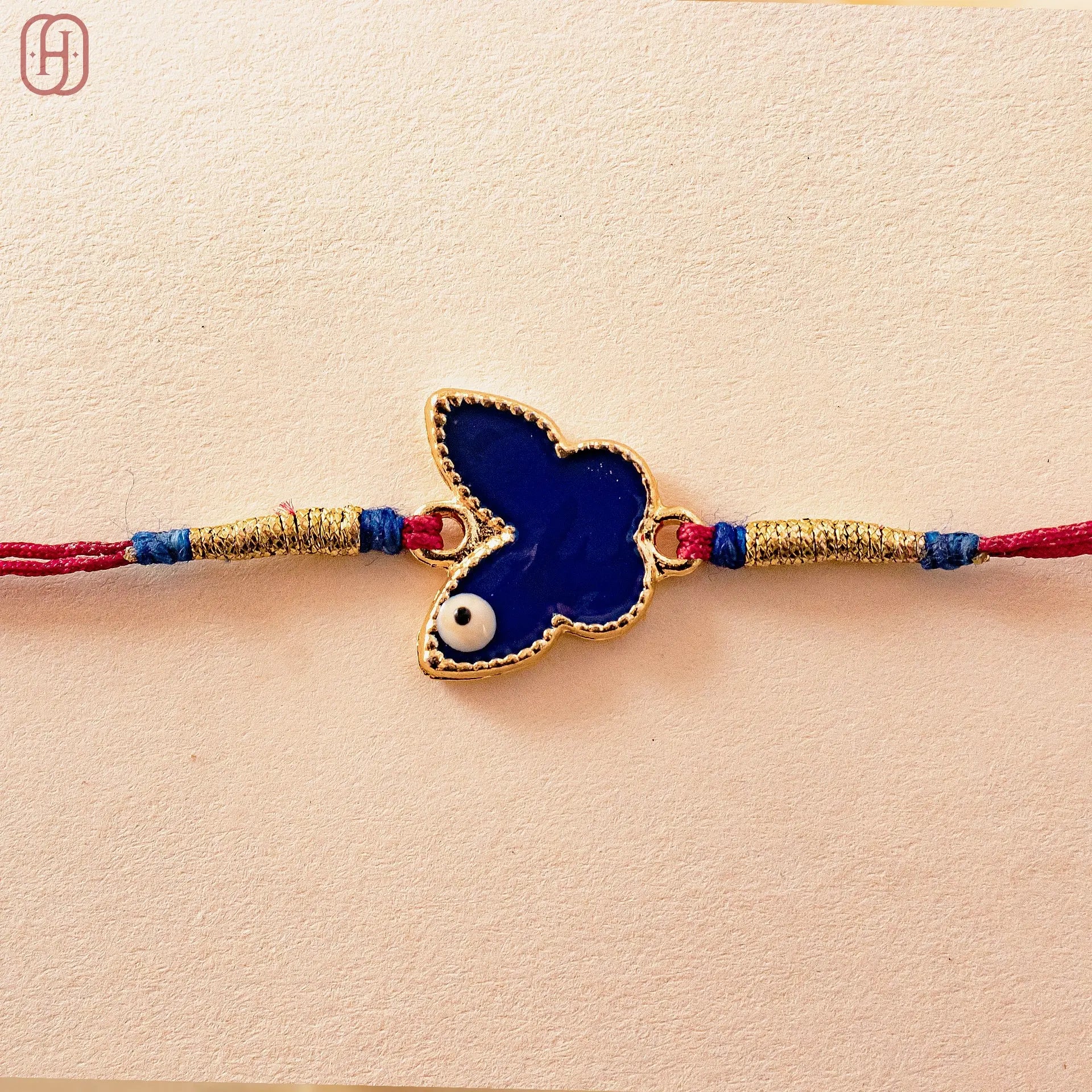 Hardik Jewels Butterfly Silver Rakhi with Blue Enamel.