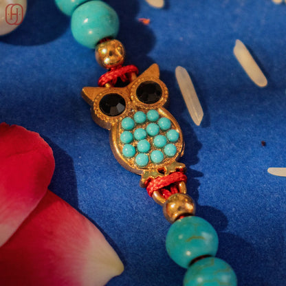 Hardik Jewels Handcrafted Owl Silver Rakhi with Turquoise Beads.