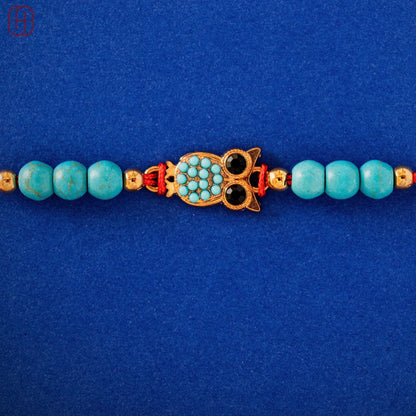 Hardik Jewels Handcrafted Owl Silver Rakhi with Turquoise Beads.
