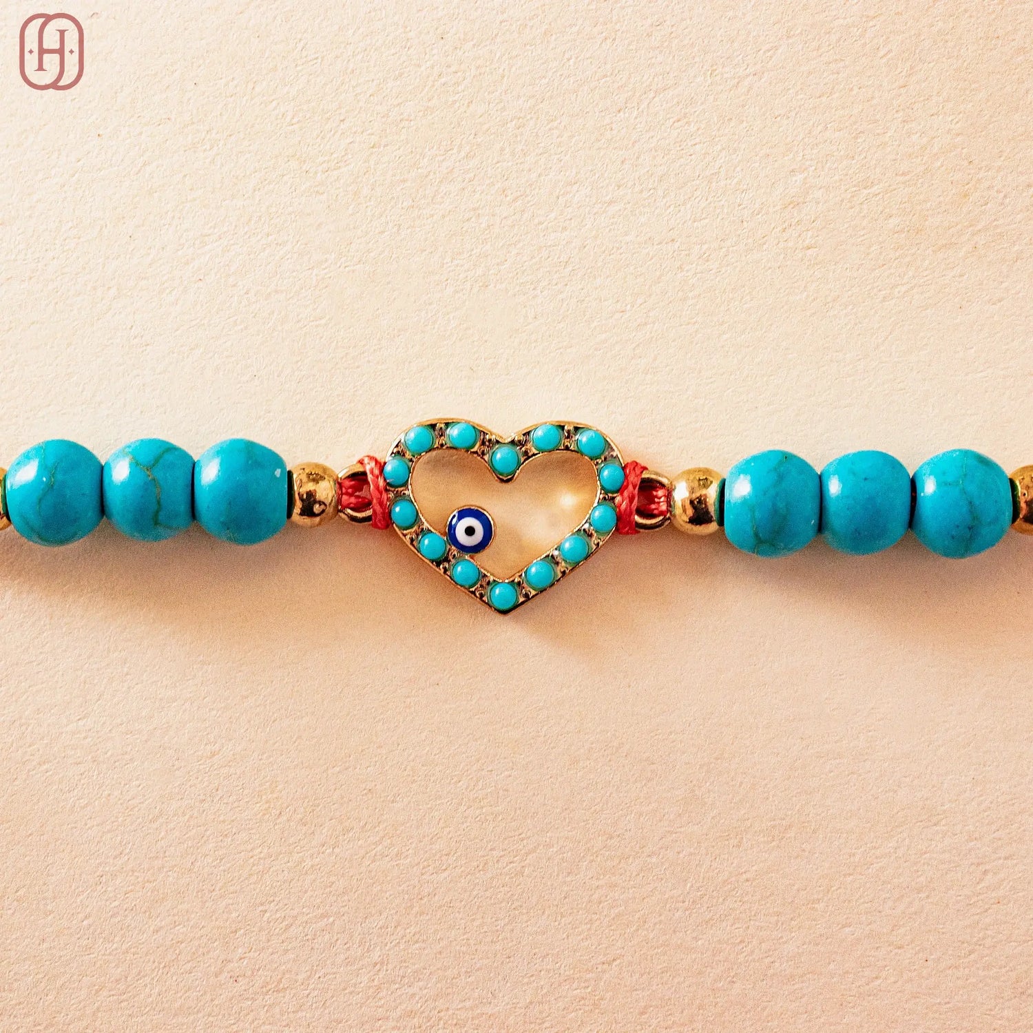 Hardik Jewels Heart Evil Eye Silver Rakhi with Blue Beads.