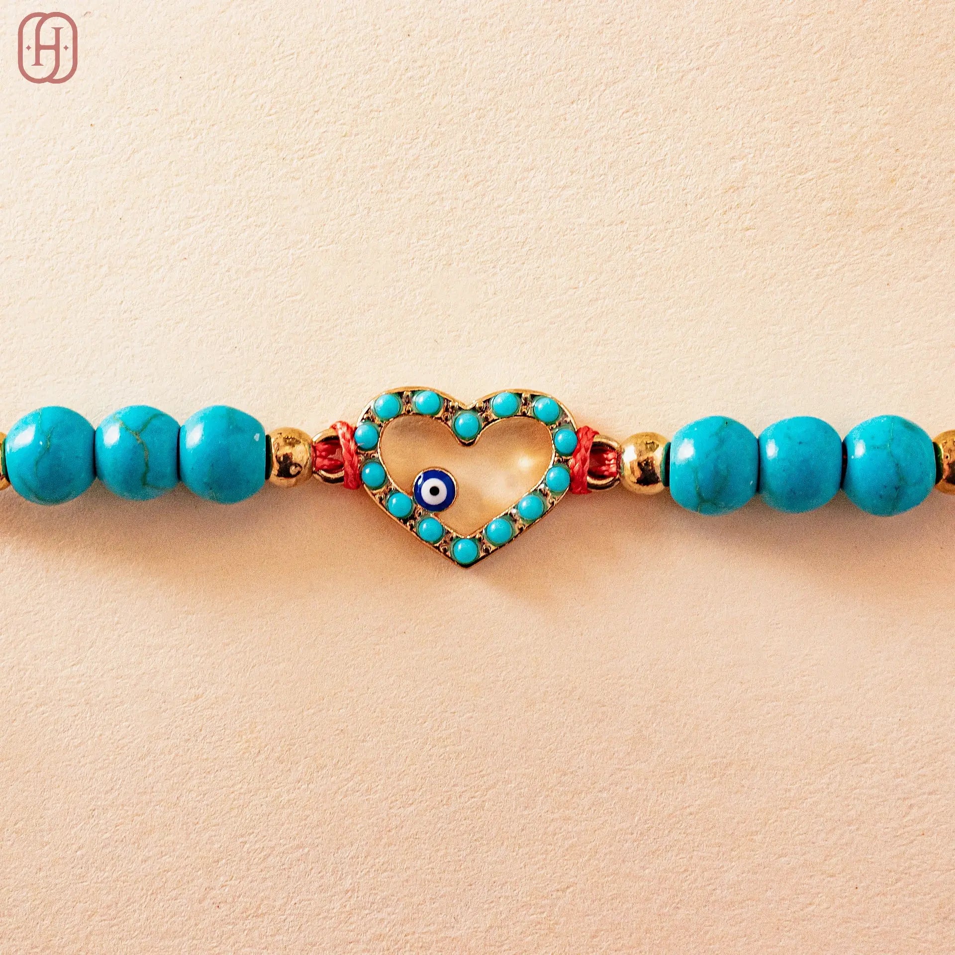 Hardik Jewels Heart Evil Eye Silver Rakhi with Blue Beads.