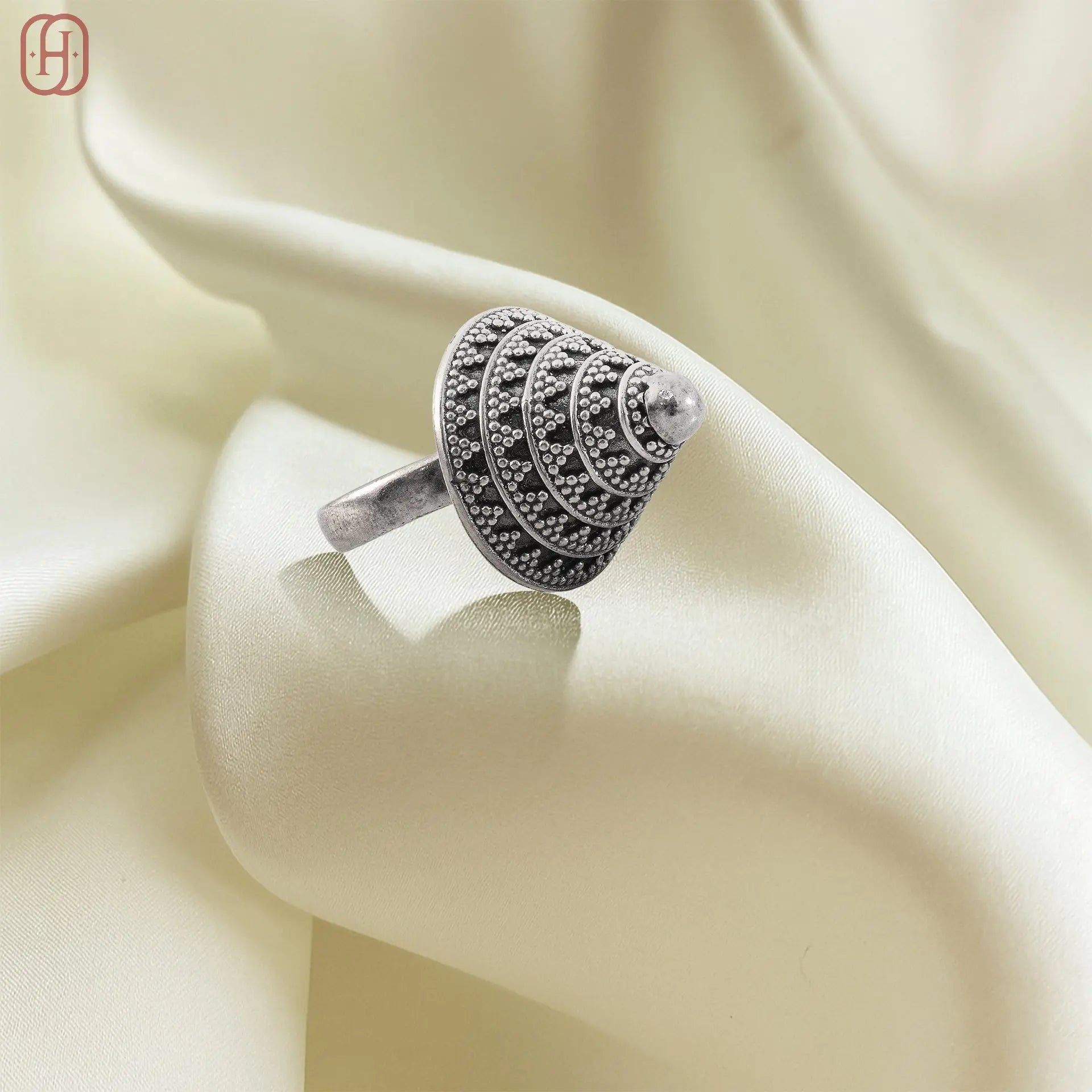 Hardik Jewels oxidized silver ring with intricate dotted patterns on a smooth cream fabric