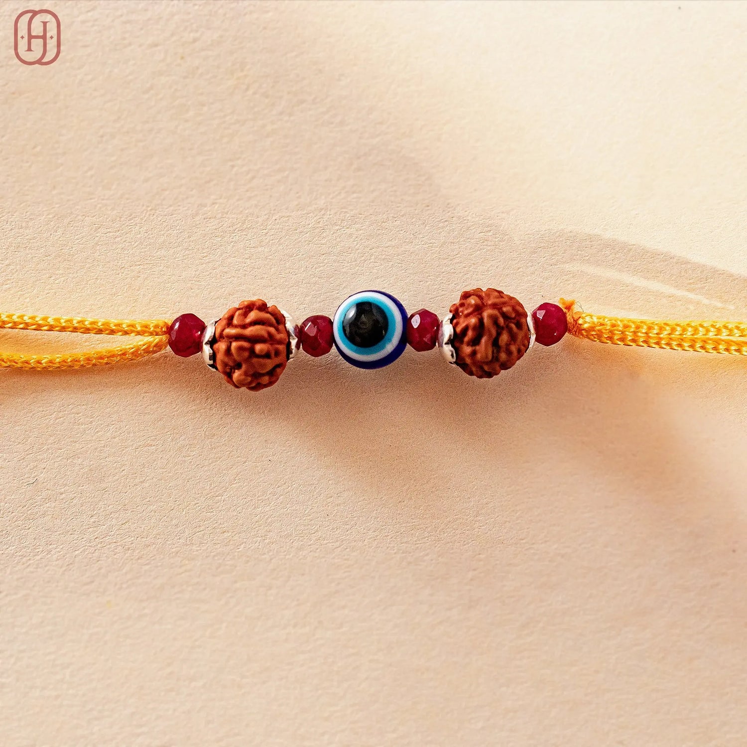 Hardik Jewels Rudraksha Evil Eye Rakhi with 92.5 Silver Beads.