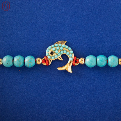Hardik Jewels Silver Fish Rakhi with Turquoise Beads.