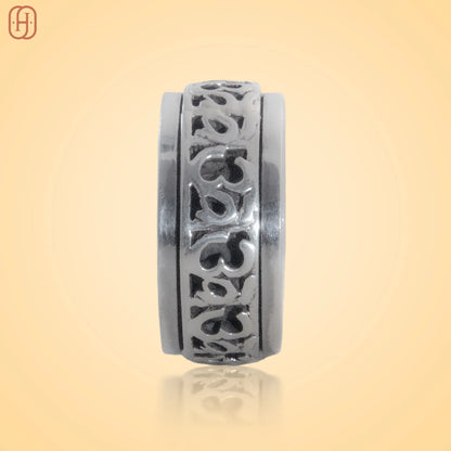 Silver Om Band jewelry with intricate carved design by Hardik Jewels on a beige background