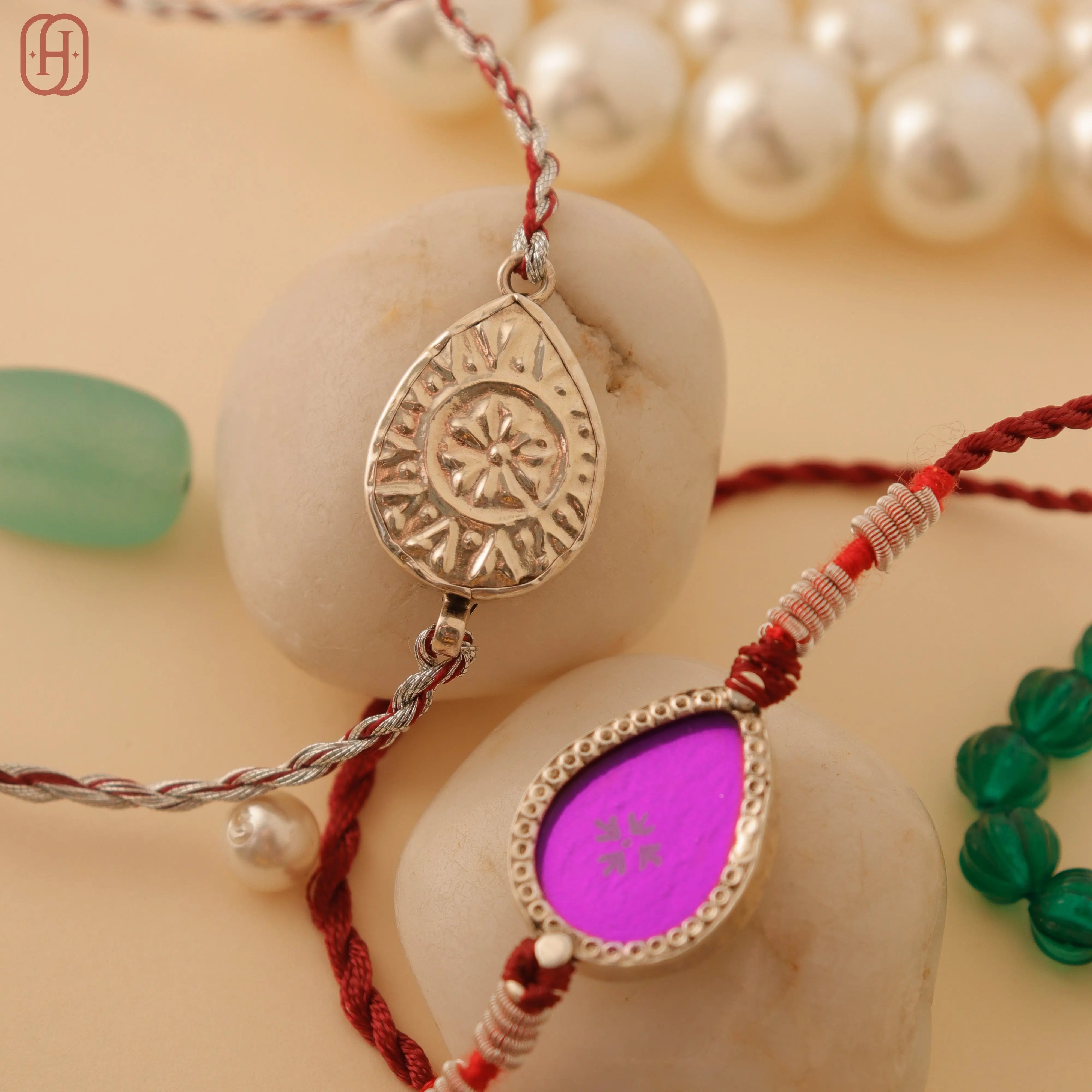 Hardik Jewels Teardrop Rakhi Design with Silver Charm.