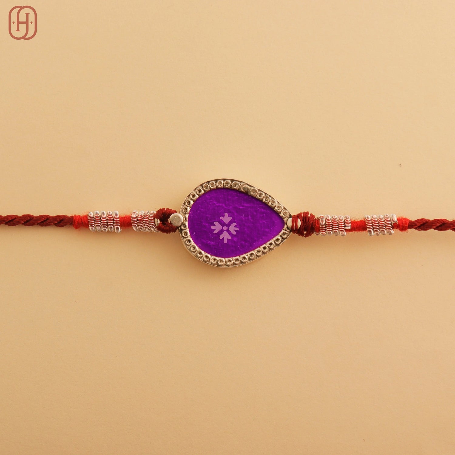 Hardik Jewels Teardrop Rakhi Design with Silver Charm.