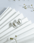 Large white button pearl stud earrings featuring a secure screw-back mechanism.
