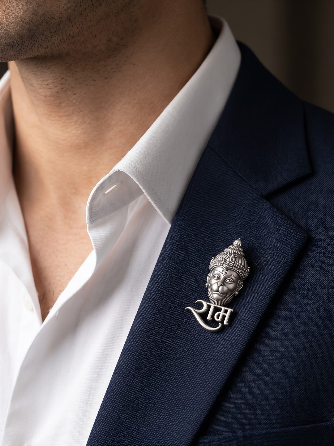 Man wearing silver Hanuman Ram naam brooch on a blazer