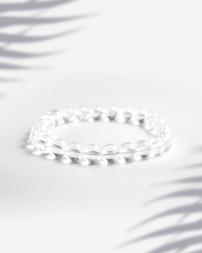 Natural Clear Quartz (Sphatik) gemstone bracelet featuring transparent round beads on a white background.