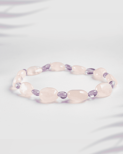 Natural Rose Quartz and Amethyst gemstone bracelet featuring tumbled oval beads on a white background.