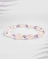 Natural Rose Quartz and Amethyst gemstone bracelet featuring tumbled oval beads on a white background.