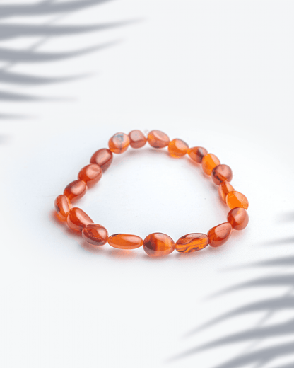 Natural carnelian gemstone bracelet featuring organic oval shaped orange beads.