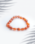 Natural carnelian gemstone bracelet featuring organic oval shaped orange beads.