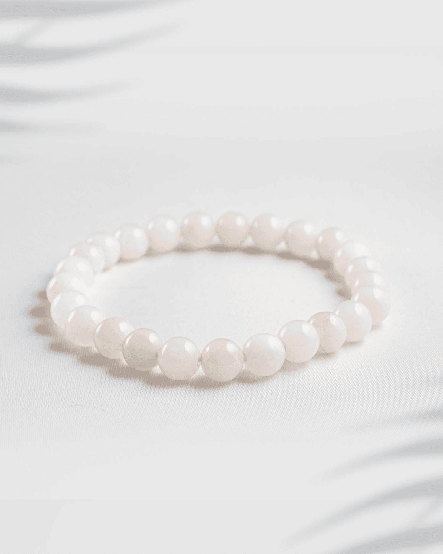 Natural gemstone bracelet featuring a mix of pink Rose Quartz and white Moonstone beads.