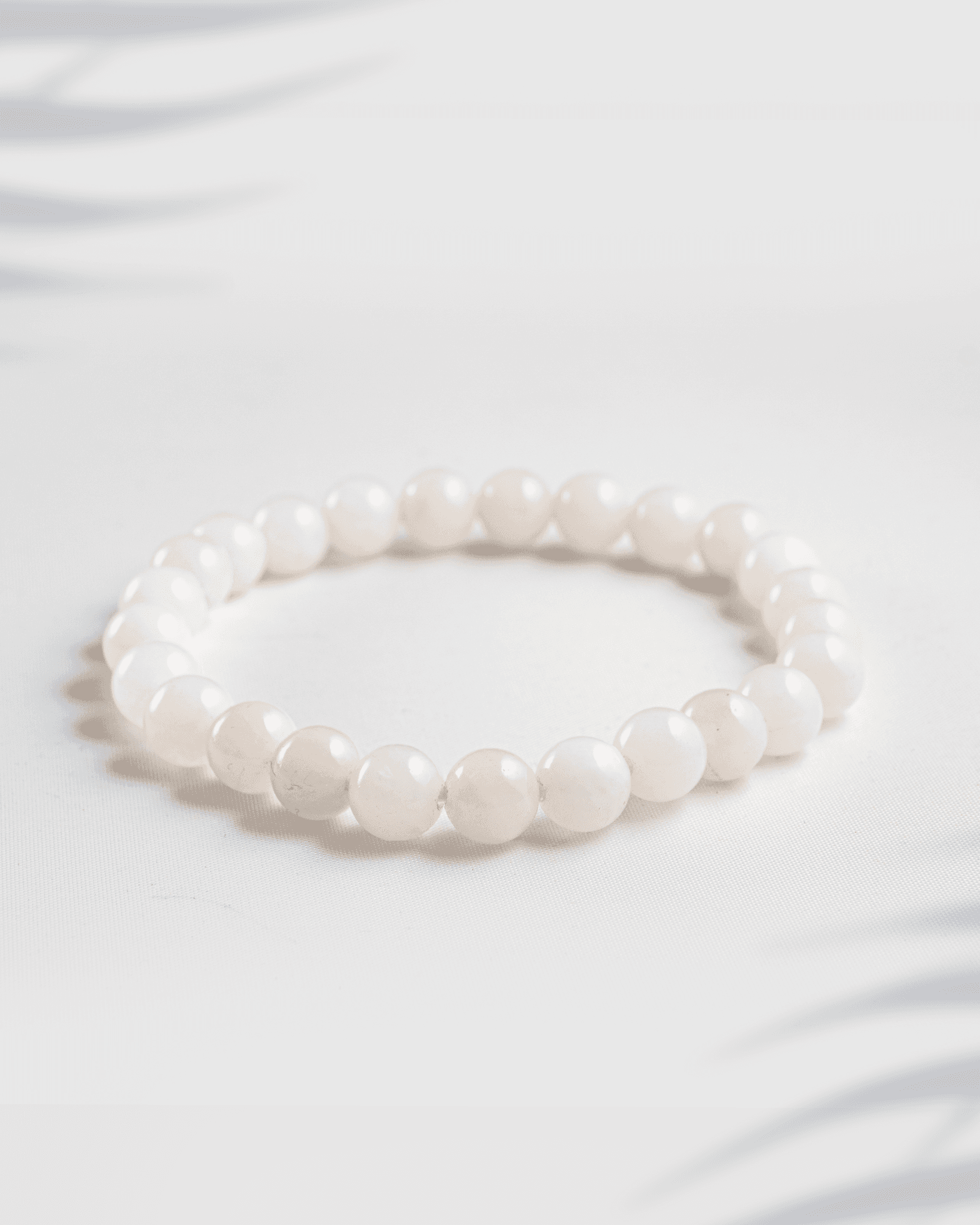 Natural gemstone bracelet featuring a mix of pink Rose Quartz and white Moonstone beads.