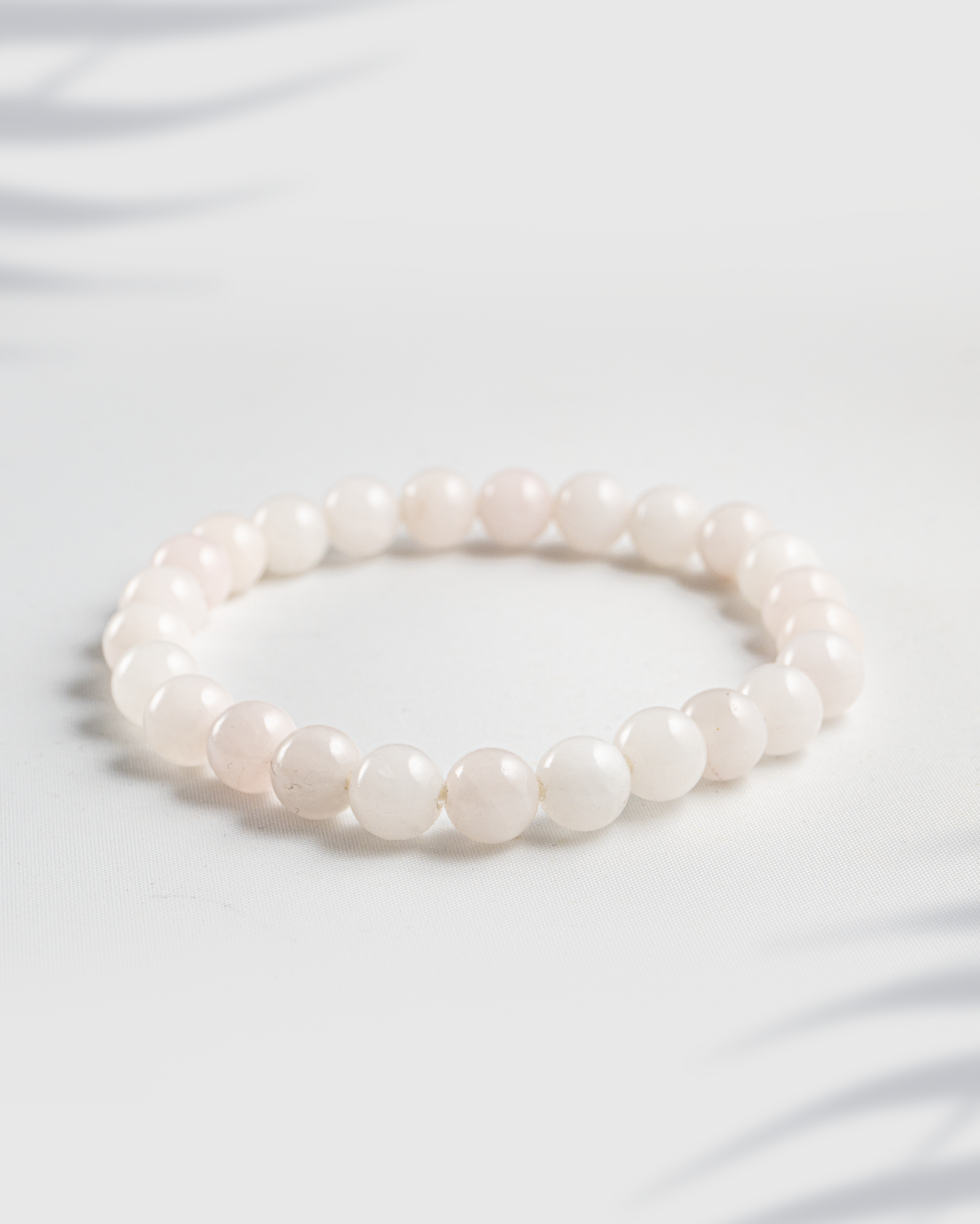 Natural gemstone bracelet featuring a mix of pink Rose Quartz and white Moonstone beads.