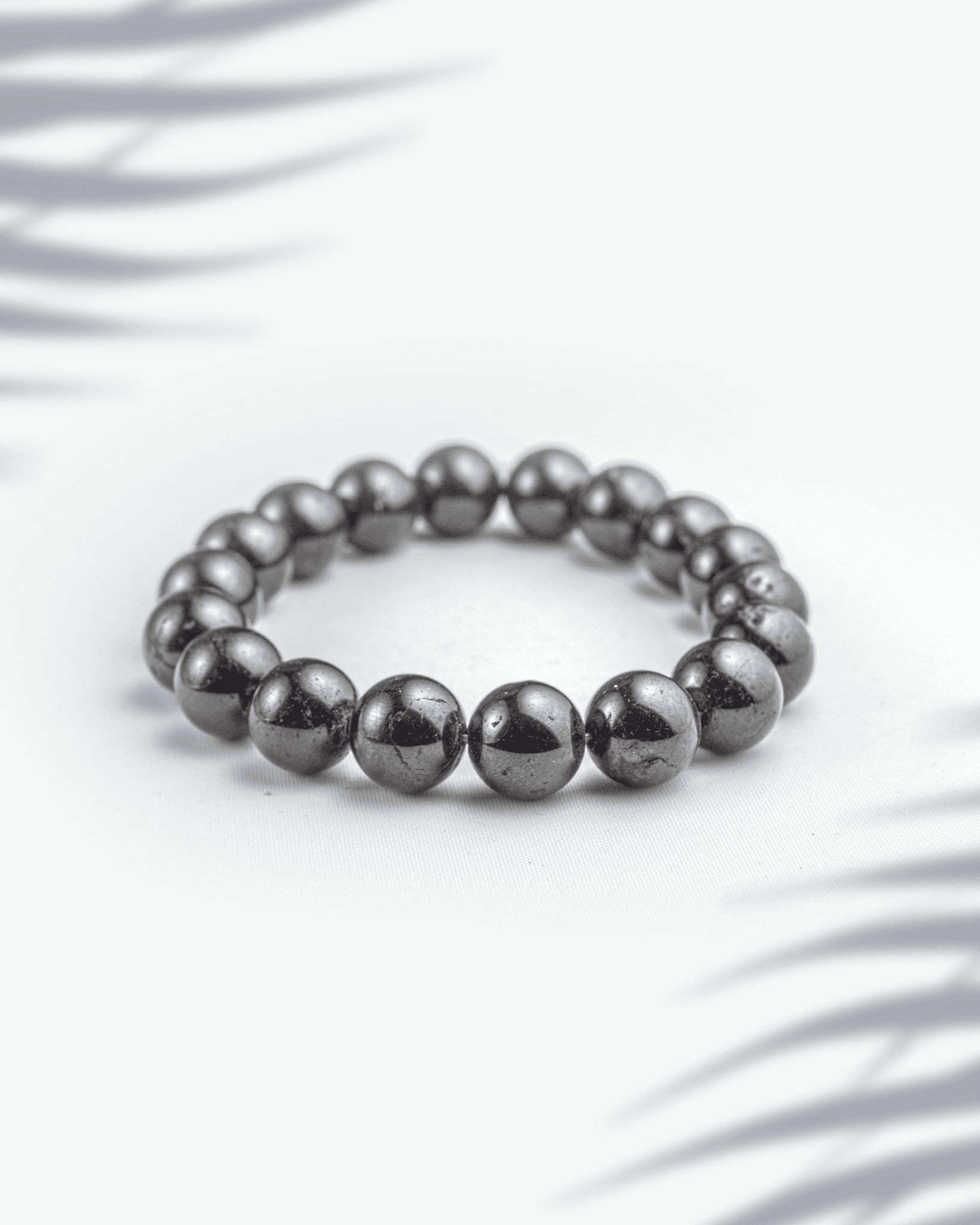 Natural red garnet gemstone bracelet featuring deep wine-red beads on a white background.