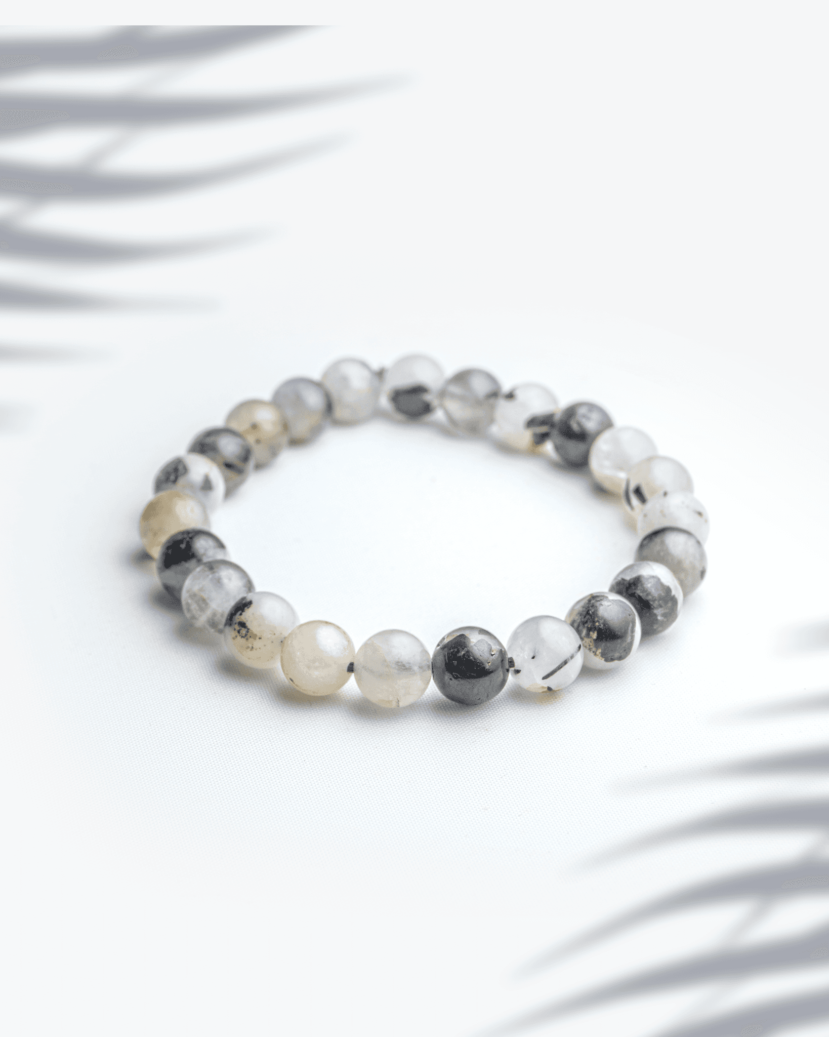 Natural silver rutilated quartz bracelet featuring grey beads with silver needle inclusions for intuition and clarity.