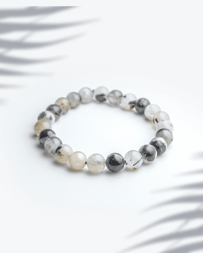 Natural silver rutilated quartz bracelet featuring grey beads with silver needle inclusions for intuition and clarity.
