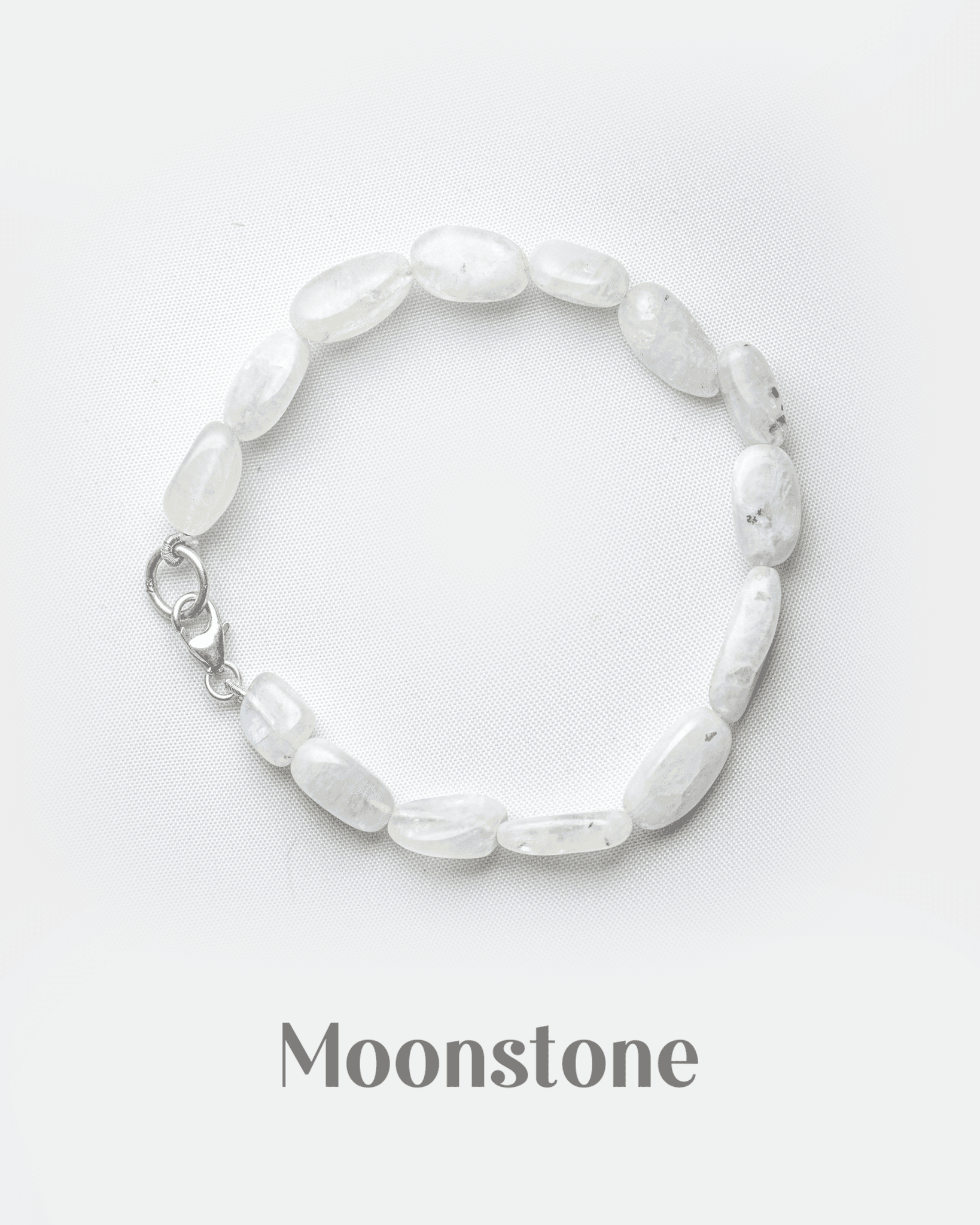 Natural white rainbow moonstone bracelet with silver lobster clasp featuring smooth milky oval beads.