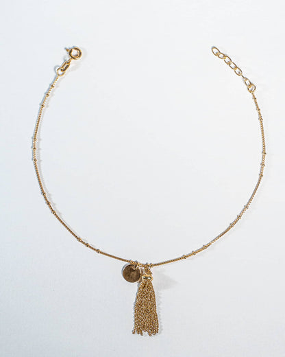 Pair of 18K gold plated sterling silver anklets with tassel on a white background