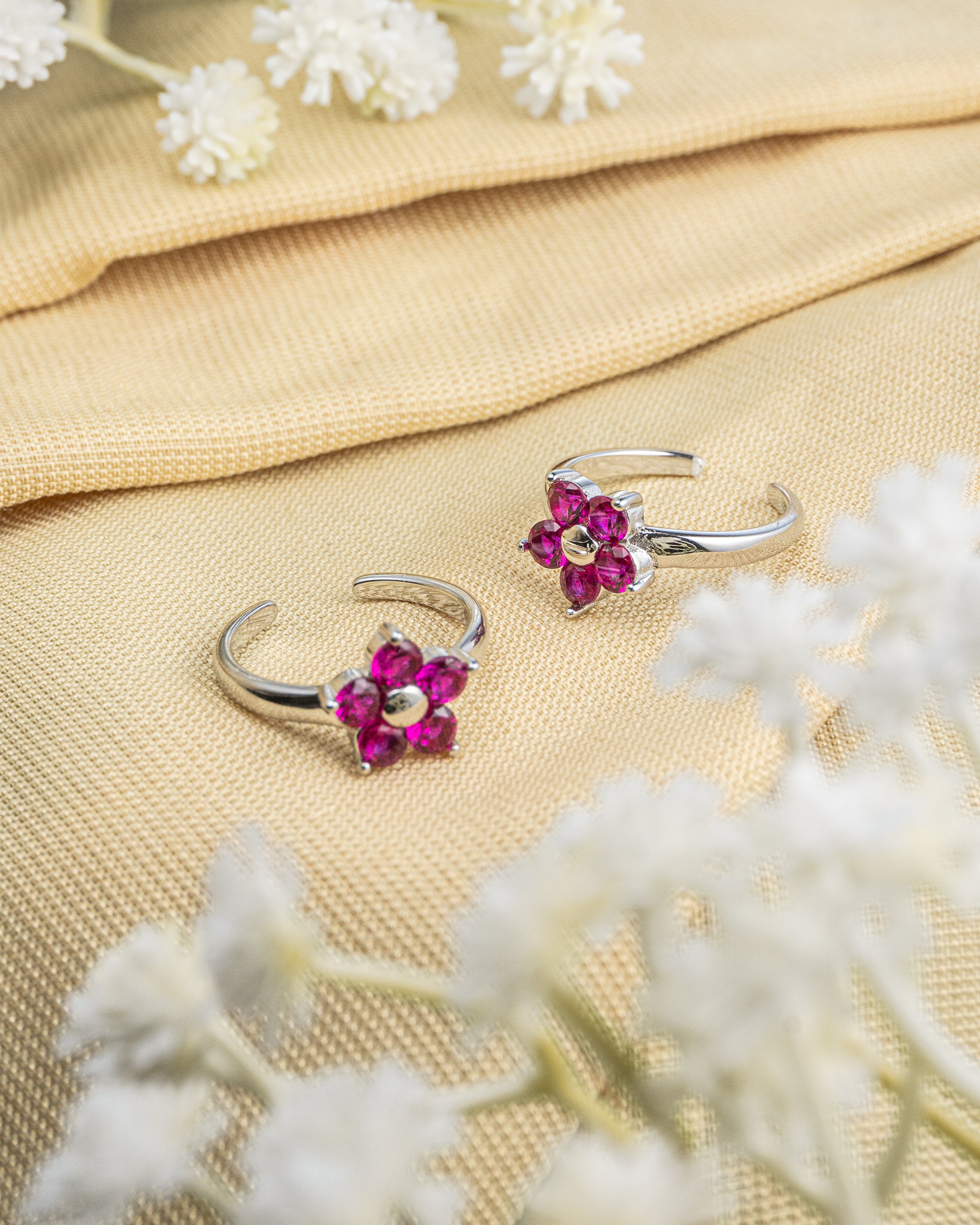 Pair of 92.5 sterling silver adjustable toe rings featuring pink stone floral design.