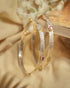 Pair of 92.5 sterling silver antique bangles featuring oxidized floral vine carving and beaded borders.