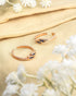 Pair of gold plated 92.5 sterling silver adjustable toe rings featuring blue stones in a wave design.