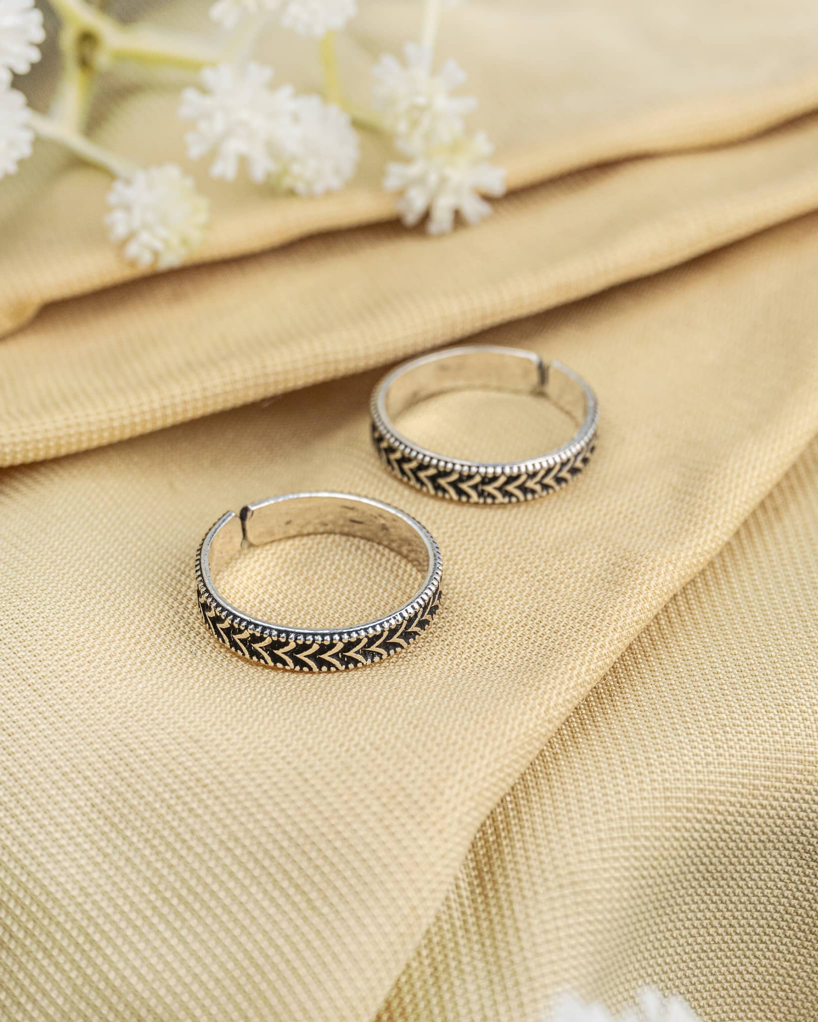 Pair of oxidized 92.5 sterling silver band toe rings featuring a braided rope texture design.