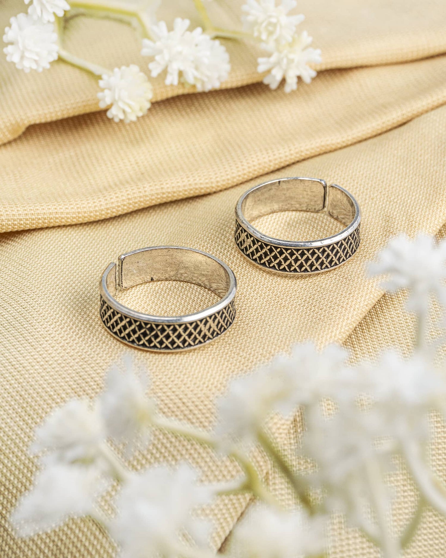 Pair of oxidized 92.5 sterling silver band toe rings featuring a geometric criss-cross mesh design.