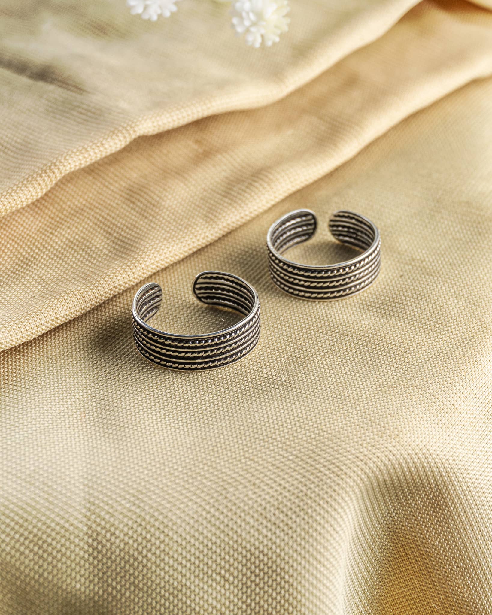 Pair of oxidized 92.5 sterling silver band toe rings featuring a triple row twisted rope design.