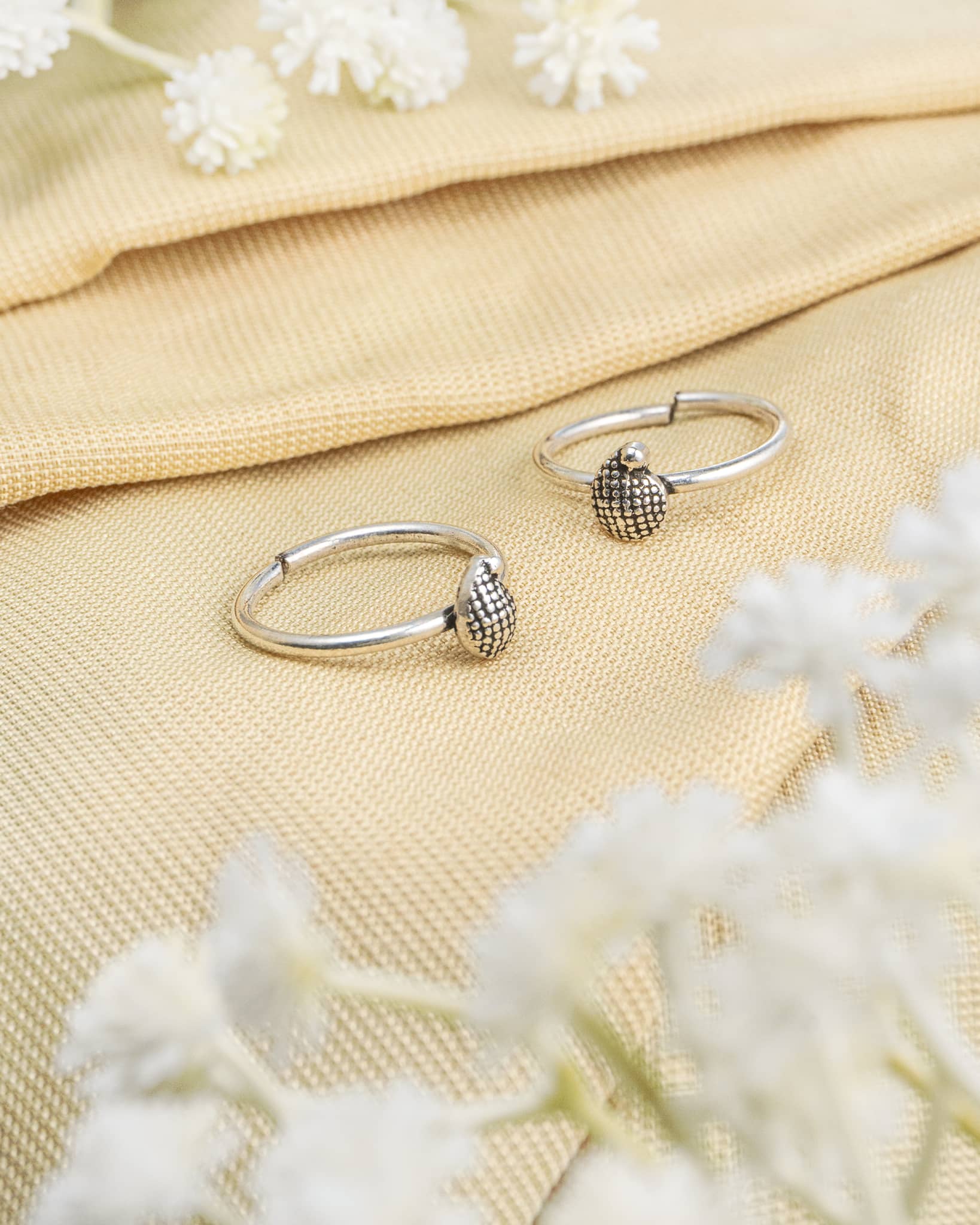 Pair of oxidized 92.5 sterling silver toe rings featuring a dotted teardrop design.