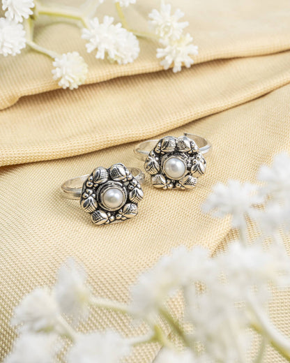 Pair of oxidized 92.5 sterling silver toe rings featuring a white pearl floral design.