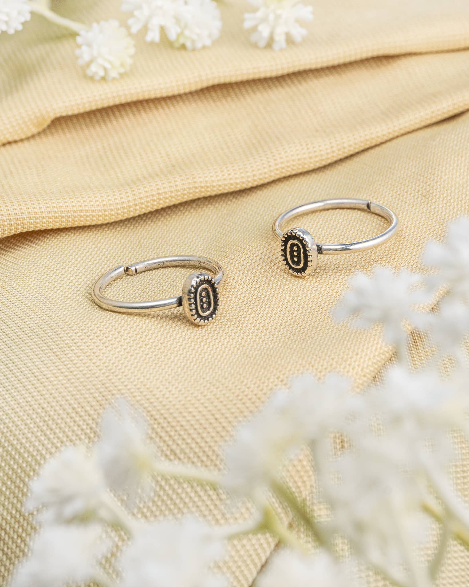 Pair of oxidized 92.5 sterling silver toe rings featuring an oval design with three vertical dots.