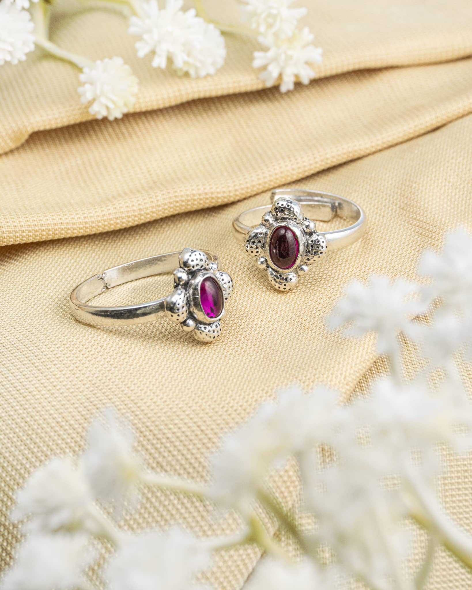 Pair of oxidized 92.5 sterling silver toe rings featuring an oval purple stone cluster design.