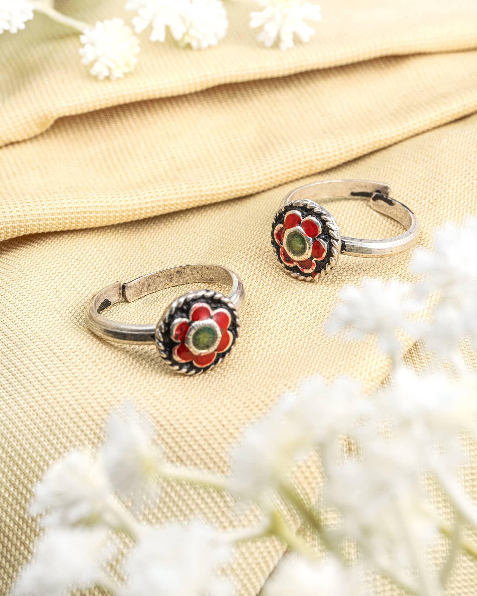 Pair of oxidized 92.5 sterling silver toe rings featuring red and green enamel meenakari work.