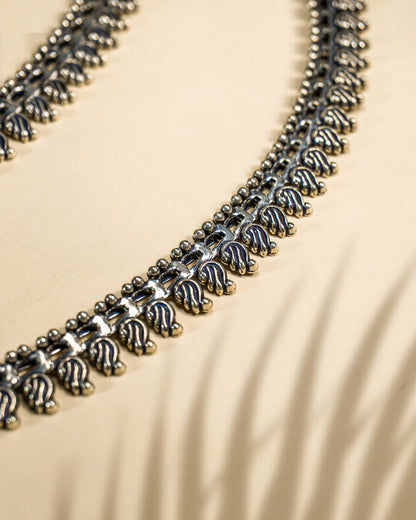 Pair of traditional oxidized silver anklets featuring repeating paisley mango motifs and small silver beads detail