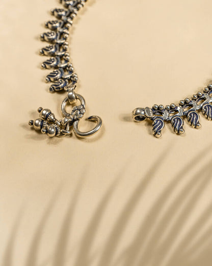 Pair of traditional oxidized silver anklets featuring repeating paisley mango motifs and small silver beads lock