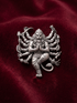 Oxidized 925 silver Narsimha multi arm lion god brooch on maroon fabric
