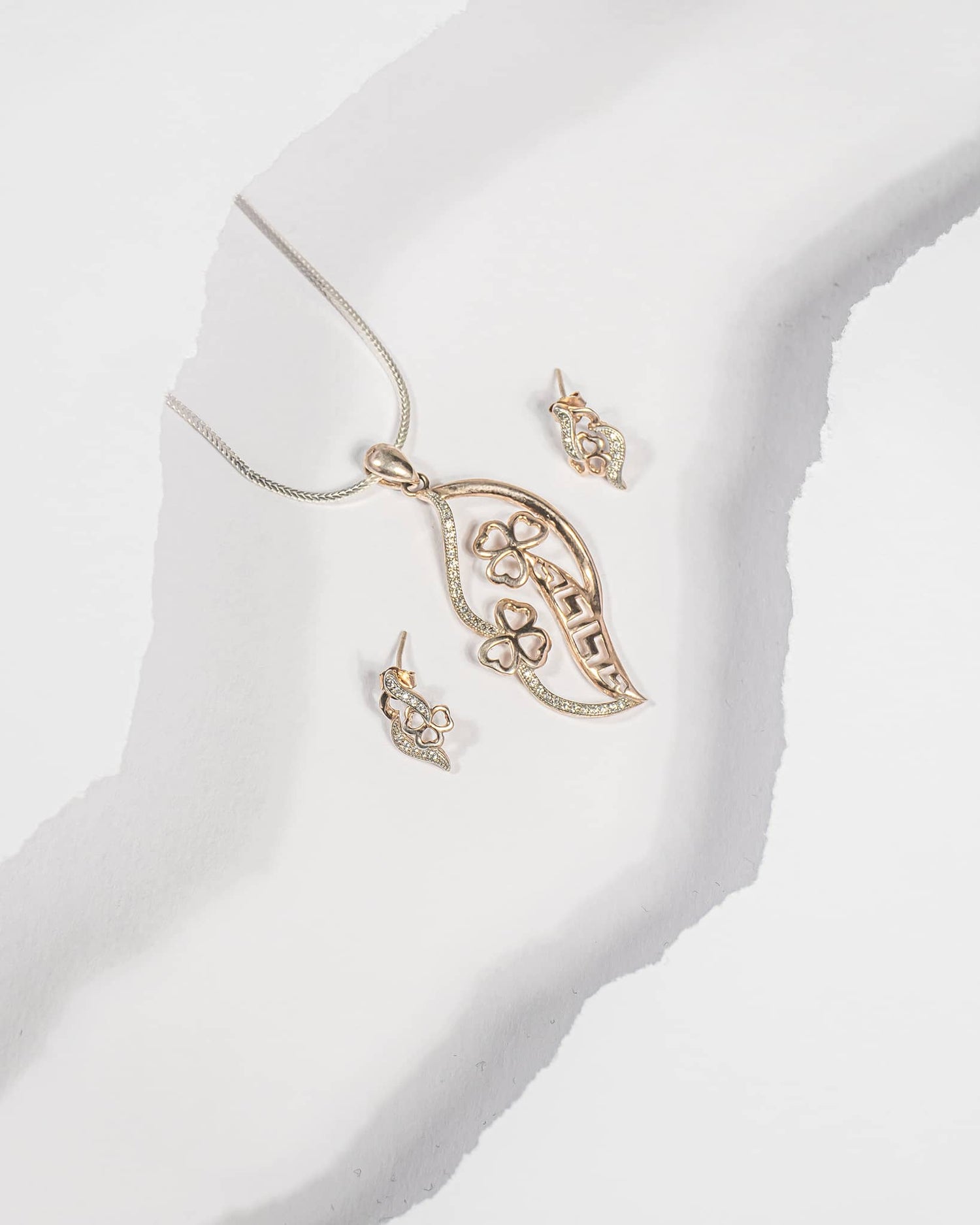 Rose gold plated 925 sterling silver pendant and earring set featuring a leaf shape with clover flowers and CZ stones (chain not included).