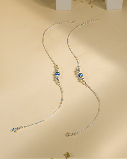 925 Sterling Silver Nazariya Payal featuring a blue evil eye bead on a snake chain, isolated on white background.