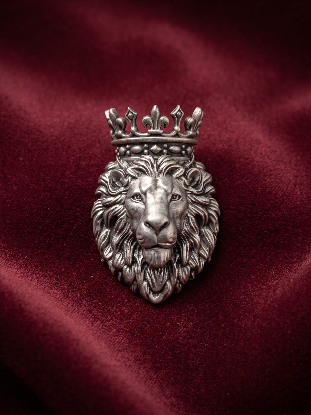 Oxidized 925 silver royal crowned lion brooch on maroon fabric