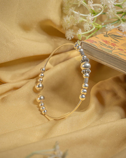 Silver open cuff bangle featuring graduated metal beads in a tribal boho design.