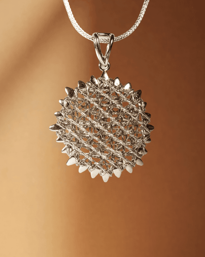 Silver textured pendant on a brown background