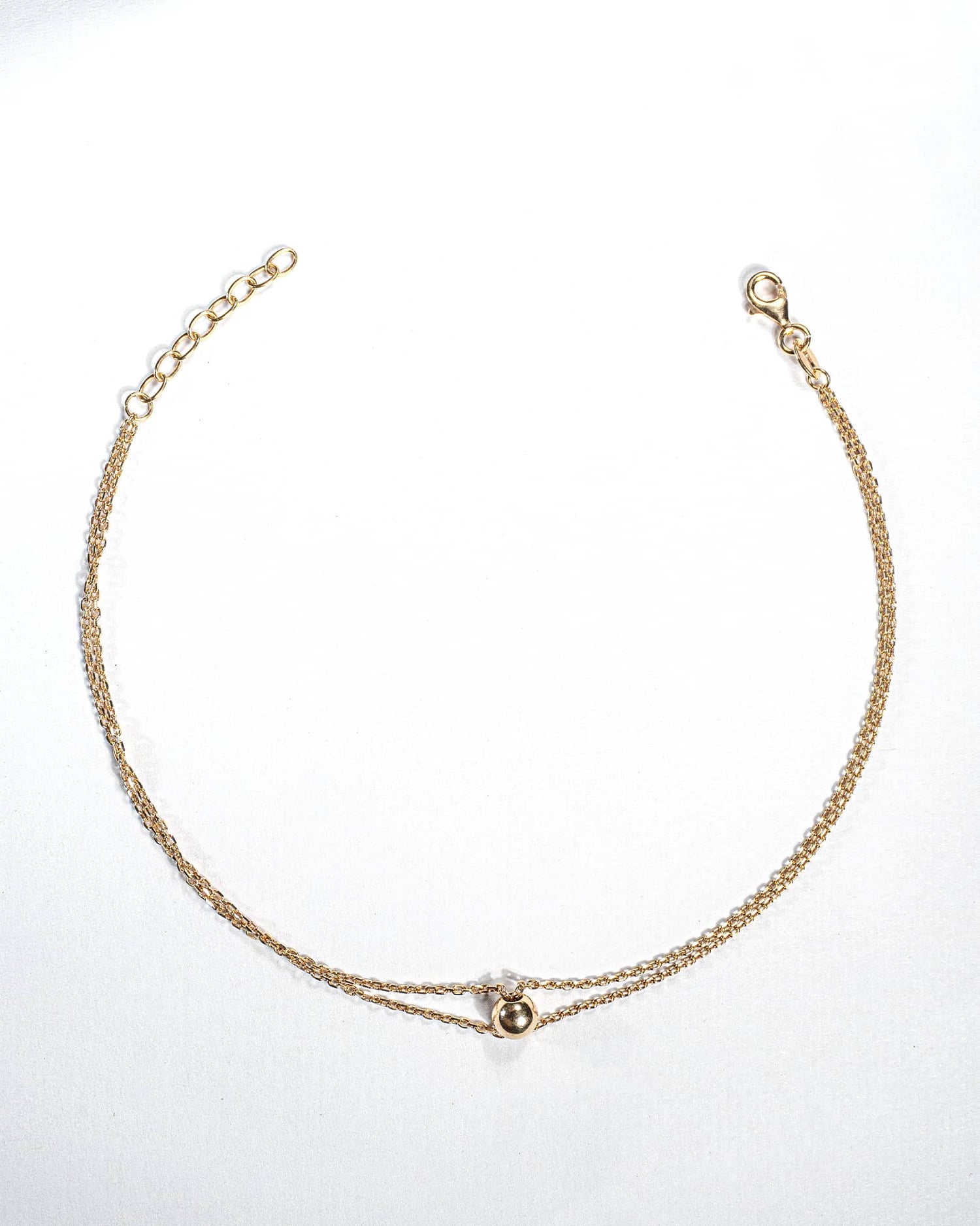 Single 18K gold plated silver anklet featuring a central polished gold ball on a delicate chain.