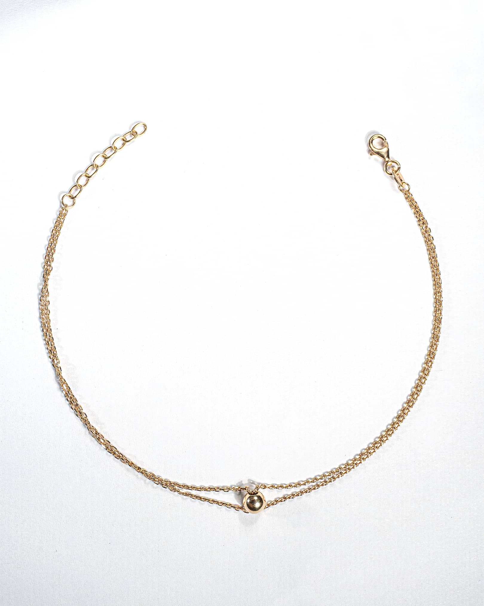 Single 18K gold plated silver anklet featuring a central polished gold ball on a delicate chain.