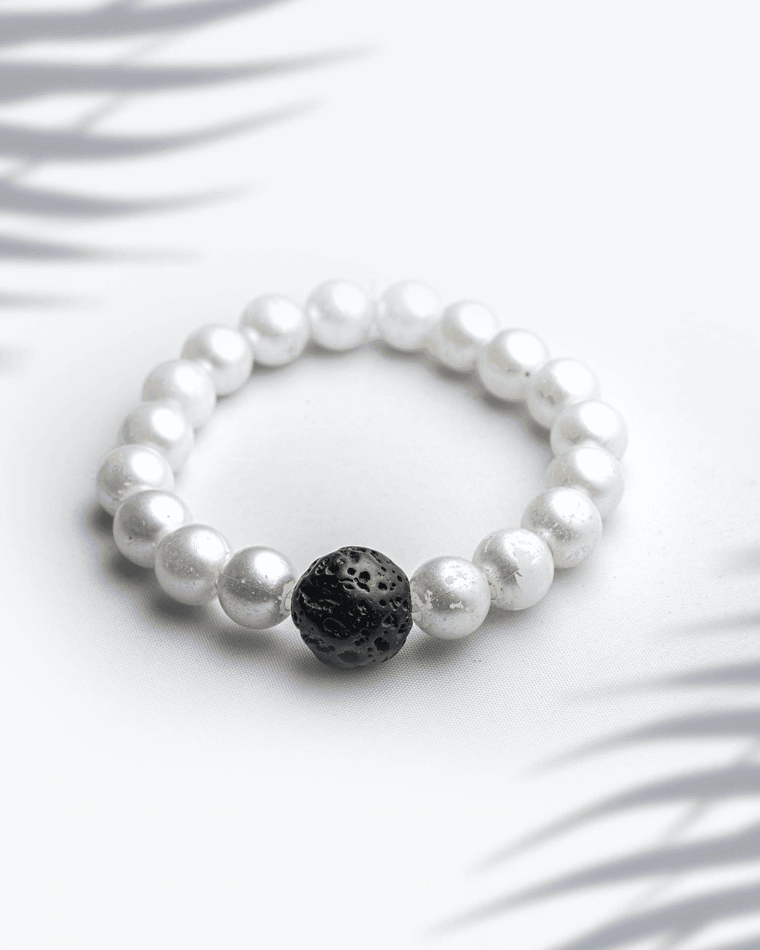 White shell pearl bracelet featuring a single black lava stone bead 9mm contrast jewelry.