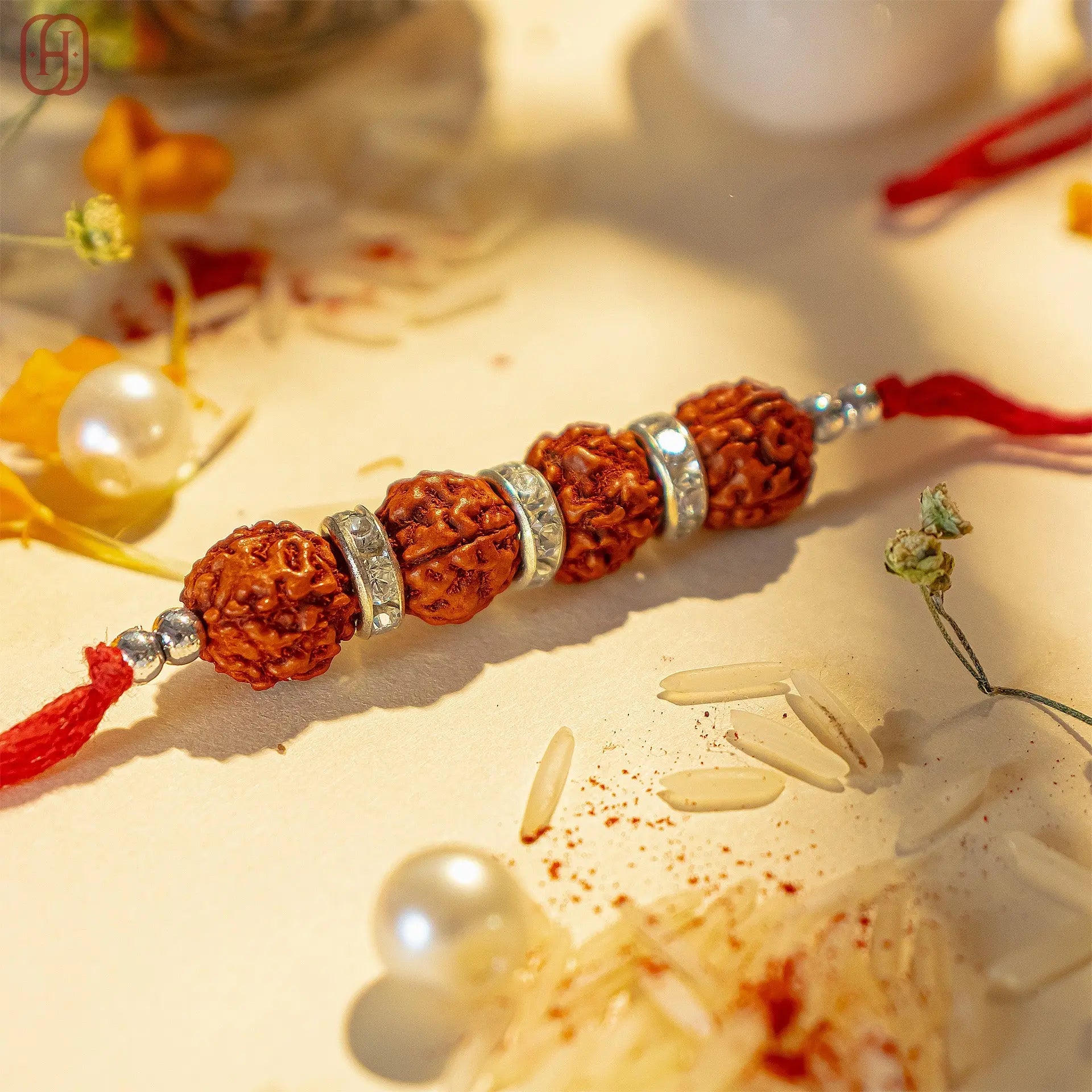 Rudraksha rakhi online featuring natural rudraksha beads with silver accents on a red thread